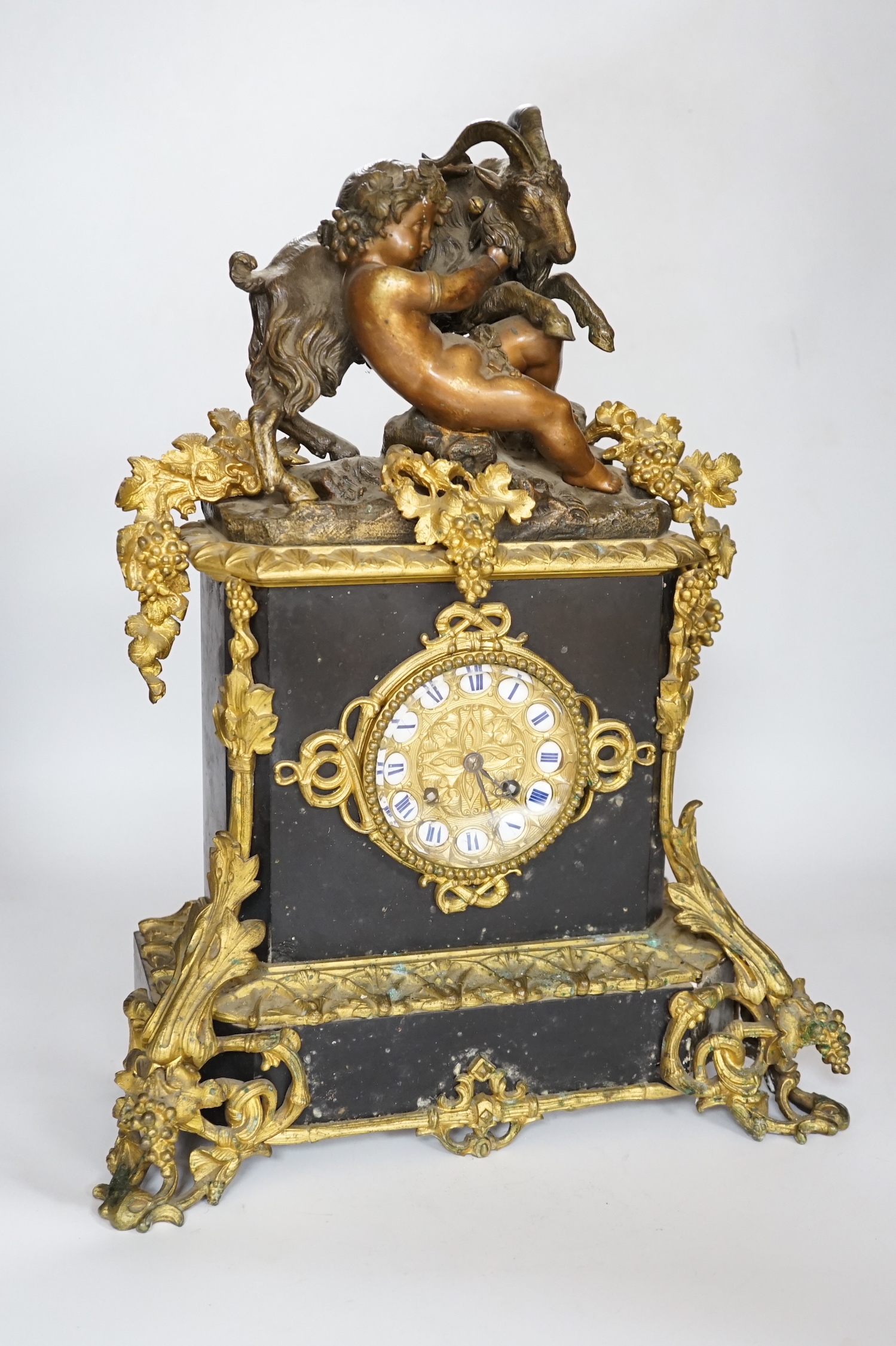 An early 20th century gilt-metal mounted mantel clock with bacchanalian group surmount, 44cm